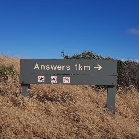 An image of a sign leading to Answers which is 1 km away.
